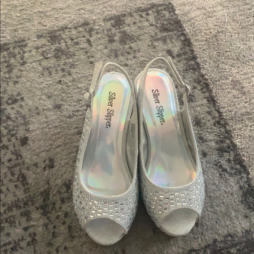 Silver wedge heels.